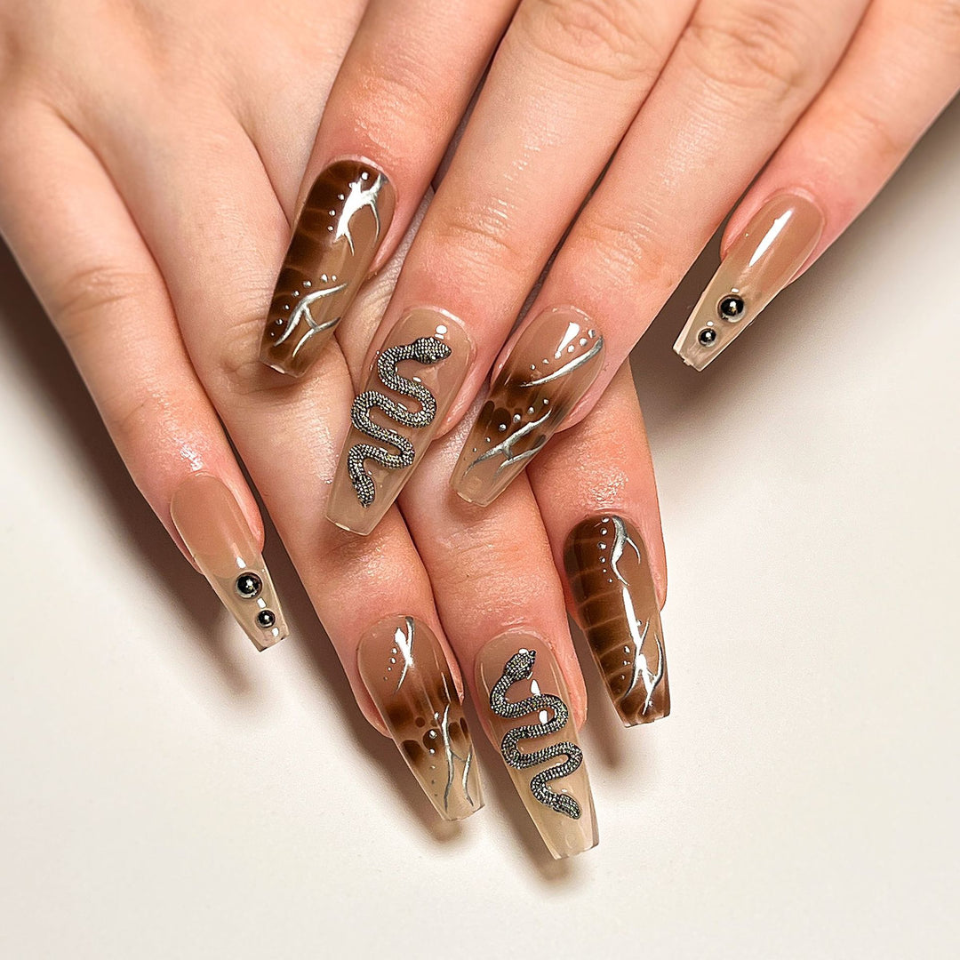 Artistic fingernails with snake and glitter accents Bowlift