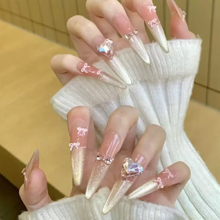Art nail set with sparkling tips and delicate bow decorations Bowlift