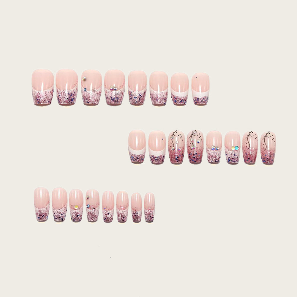 Glamorous artificial nails with glitter and rhinestone embellishments Bowlift