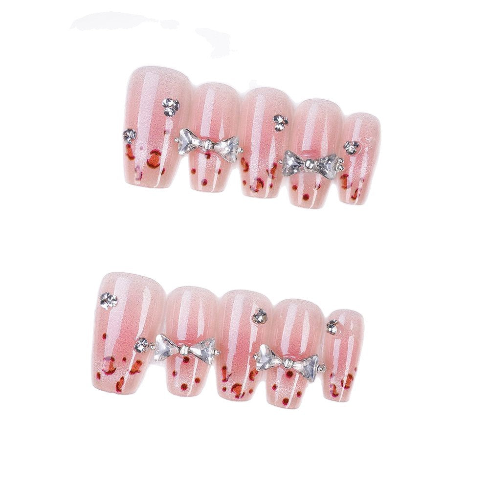 Art nails with delicate rhinestone and bow accents Bowlift
