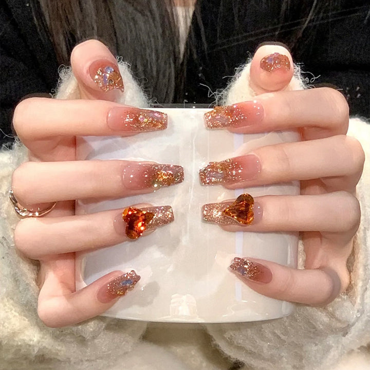 Artificial nail set with glitter and heart accents Bowlift
