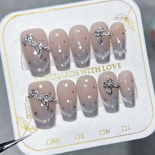 Artificial nail art with glitter details and bow accents Bowlift
