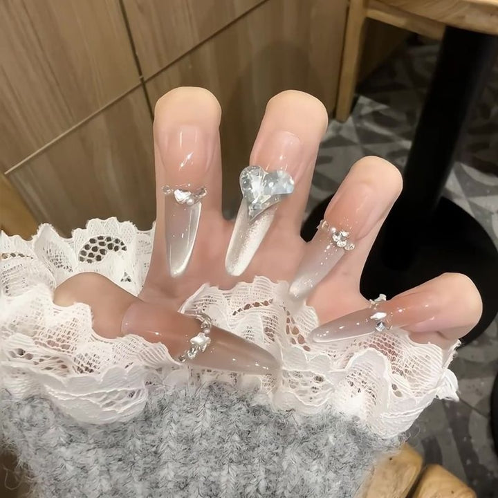 Acrylic nail set with elegant tips and glamorous rhinestone accents Bowlift