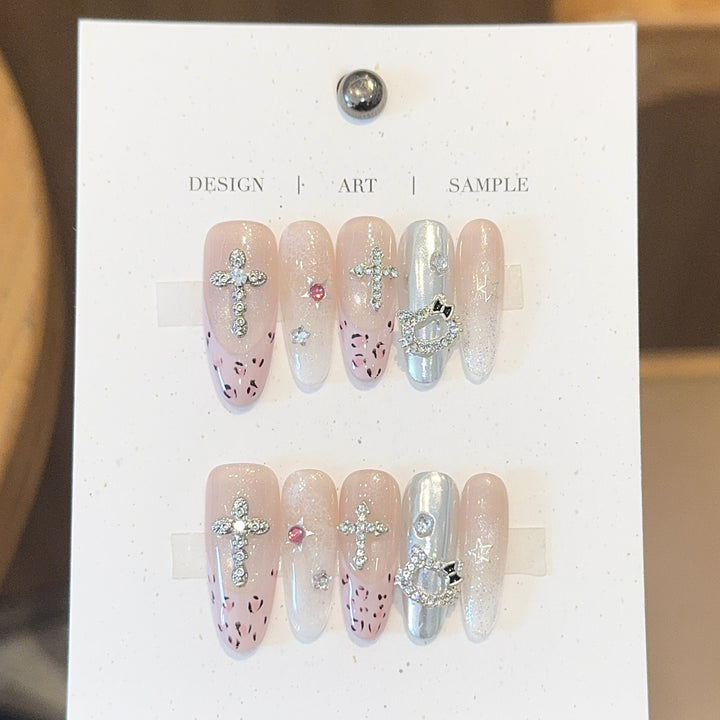 Artificial nails with sparkling rhinestones and cross motifs Bowlift