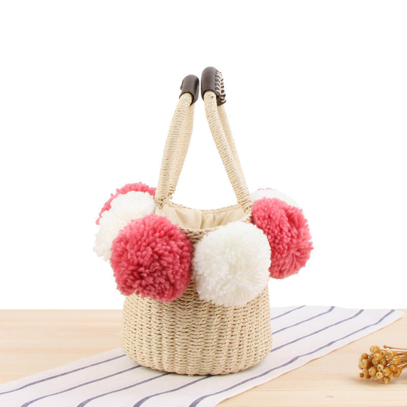 Basket bag with pompom decorated top edge Bowlift