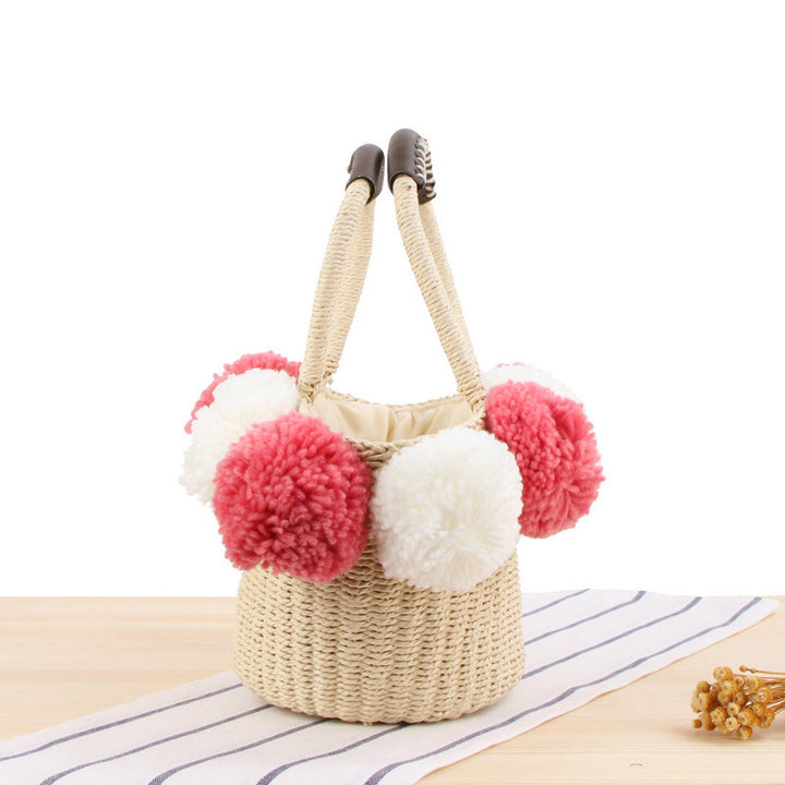 Basket bag with pompom decorated top edge Bowlift