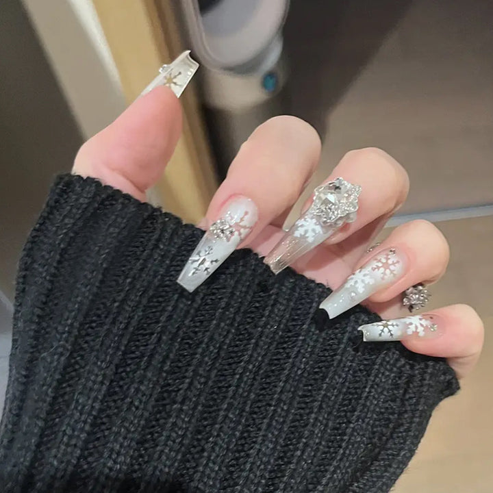 Artificial nail set with frosty snowflake design and sparkling 3D applications Bowlift