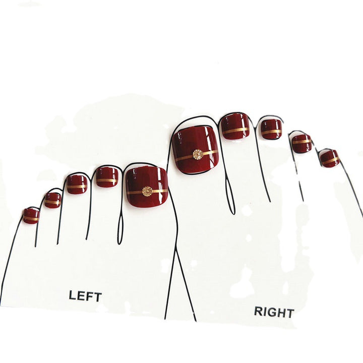 Artificial toenails with elegant gold embellishments Bowlift