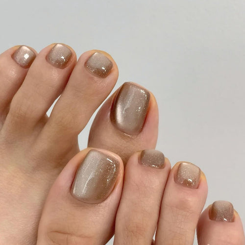 Artful nail art with glitter accents and soft ombre effect Bowlift