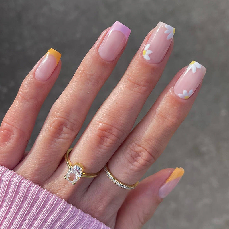 Artistic acrylic nails with floral design and creative color accents Bowlift