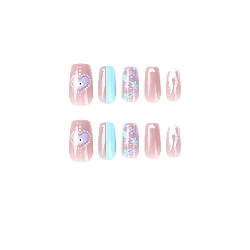 Artful nail art with floral accents and glitter embellishments Bowlift