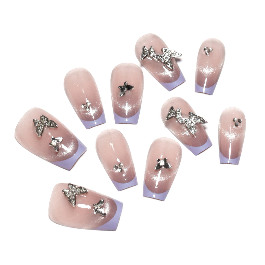 Artificial nail extensions with glitter design and elegant accents Bowlift