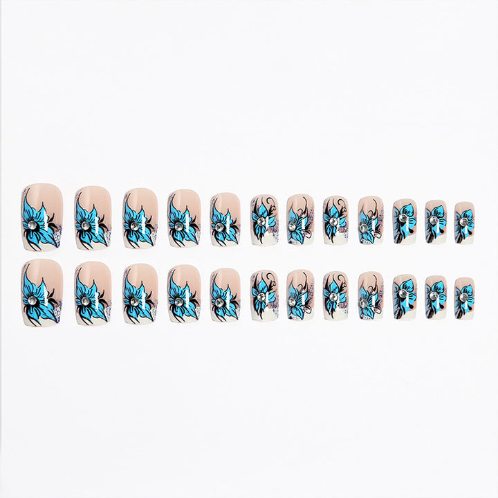 Artificial nail set with intricate floral designs and glitter elements Bowlift