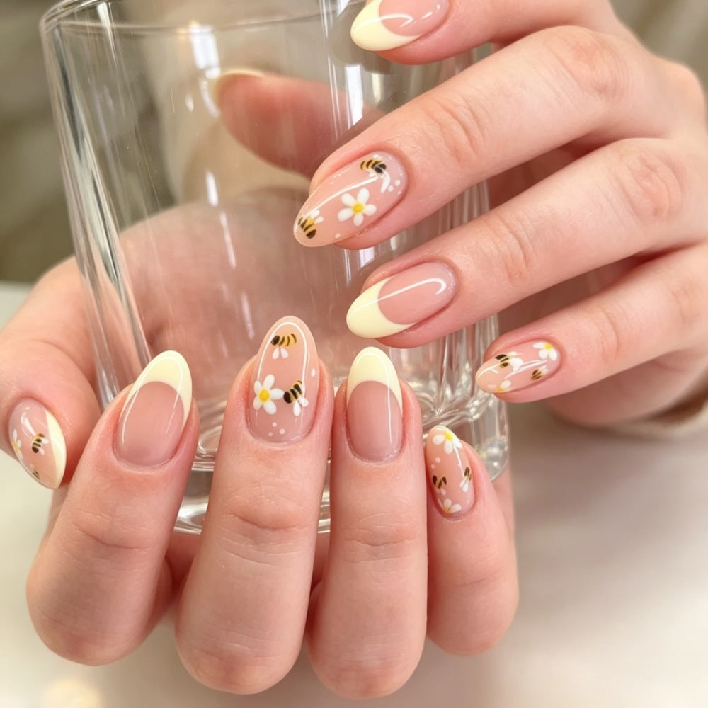 Artificial nails with elegant French tip and floral accents Bowlift