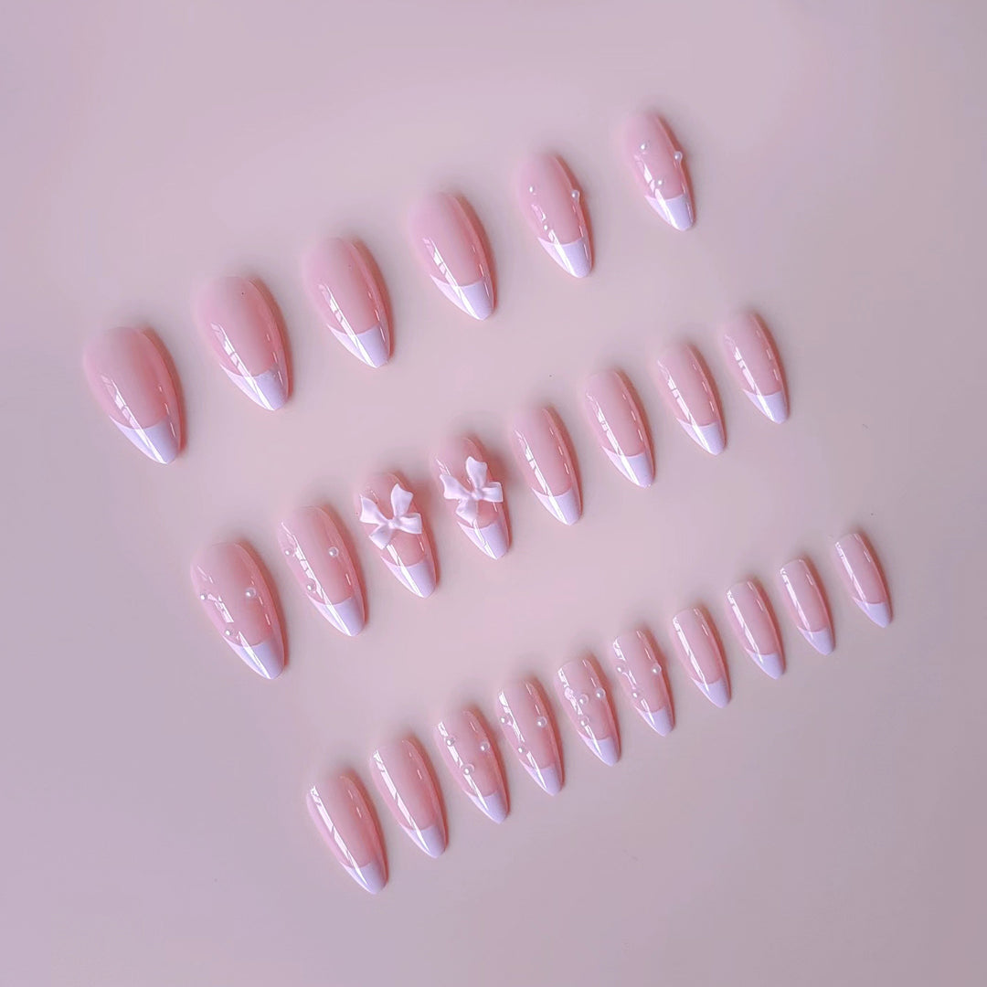 Artificial nail set with shimmering 3D bows and elegant pearl accents Bowlift