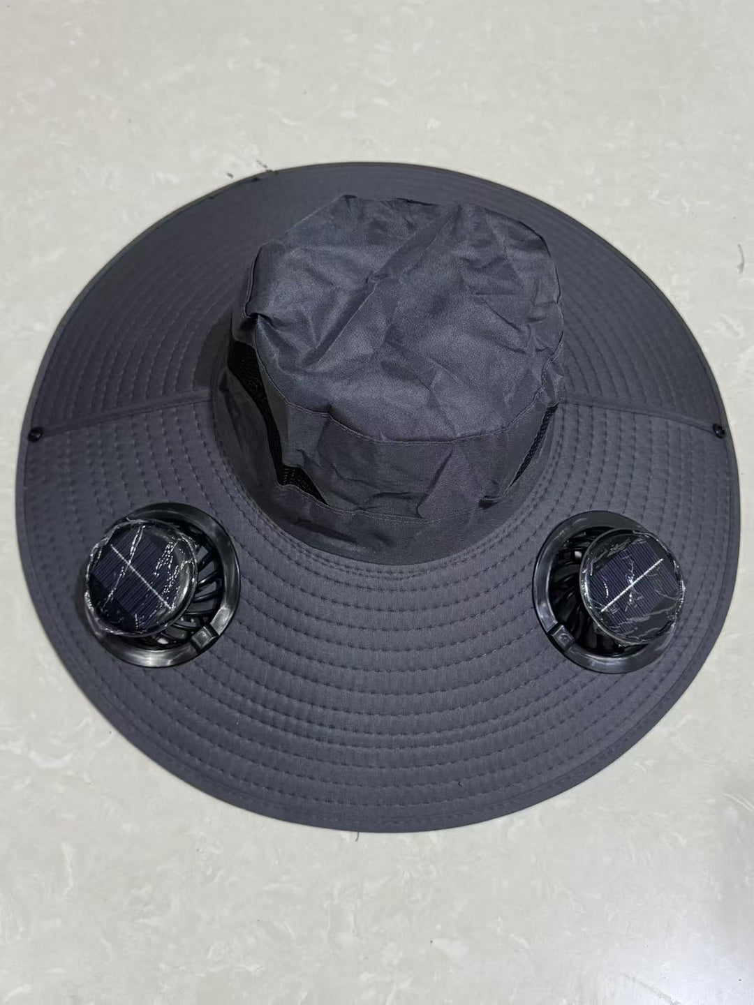 Ventilated sun hat with integrated battery fans, breathable mesh inserts, and adjustable chin strap Bowlift