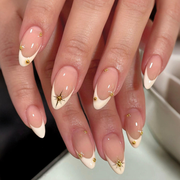 Artistic French-tip nail art with glitter and elegant embellishments Bowlift