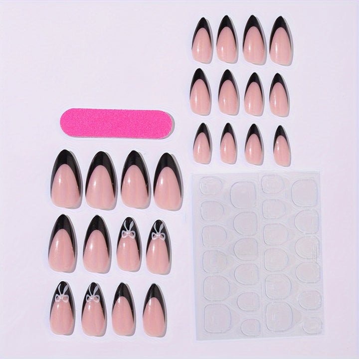 Acrylic nail set with elegant black and white design and cute bow accents Bowlift