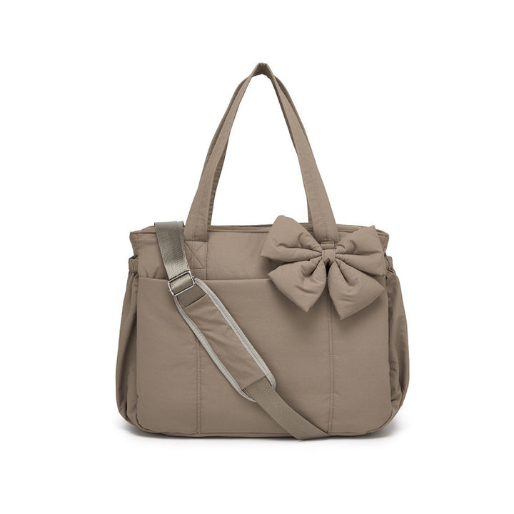 Fashionable tote bag with elegant bow appliqué Bowlift