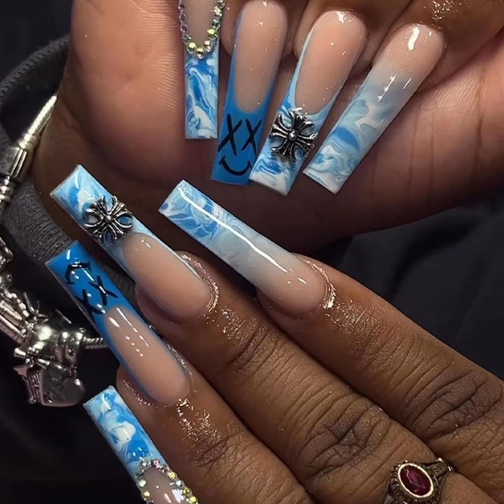 Artistic acrylic nails with marbled design and unique embellishments Bowlift