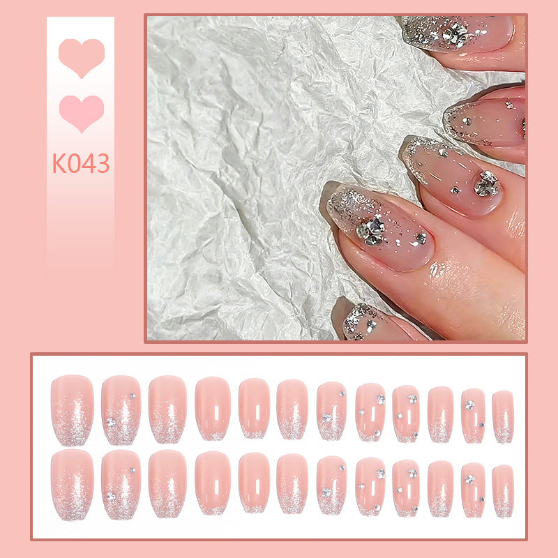 Glamorous artificial nails with glitter and rhinestone embellishments Bowlift