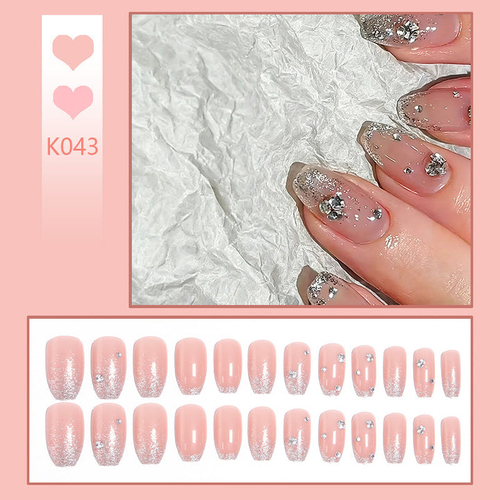 Glamorous artificial nails with glitter and rhinestone embellishments Bowlift