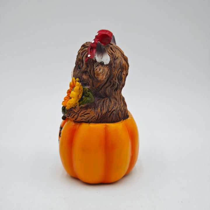 Funny decorative figure of a Highland cow in pumpkin costume Bowlift