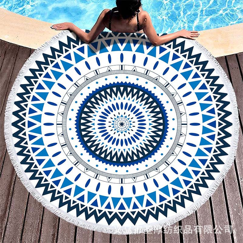 Round beach towel with colorful, tropical floral pattern and fringe decoration Bowlift