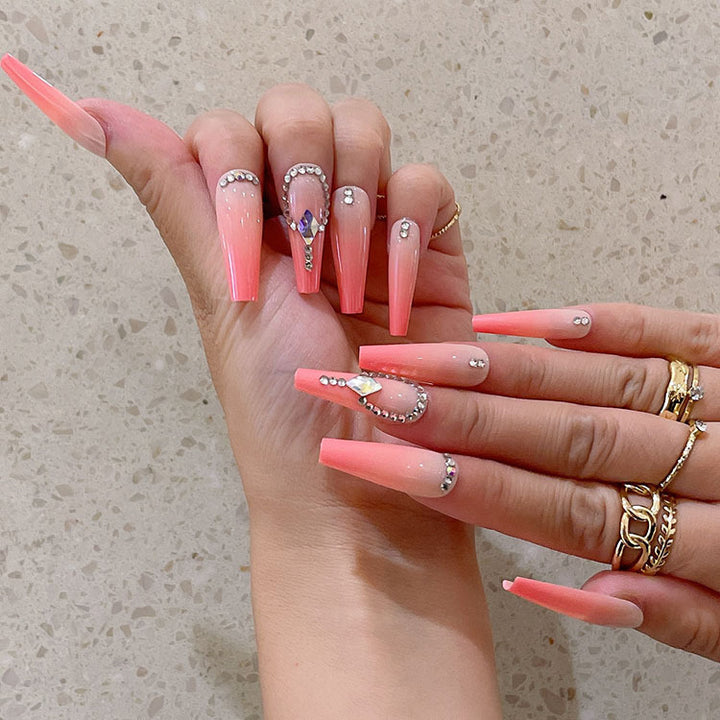 Artificial nails with glitter and stone embellishments Bowlift