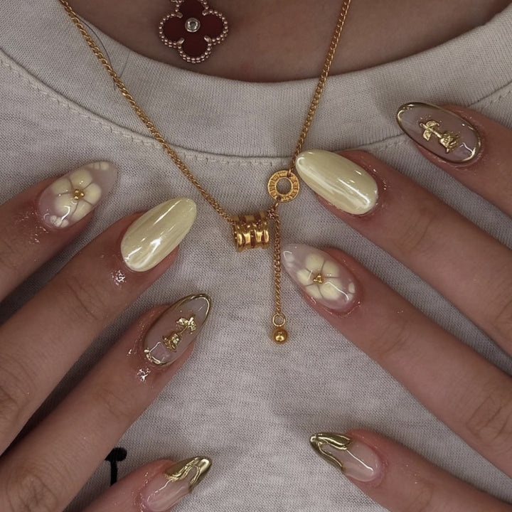 Artful nail art with floral decorations and glitter accents Bowlift