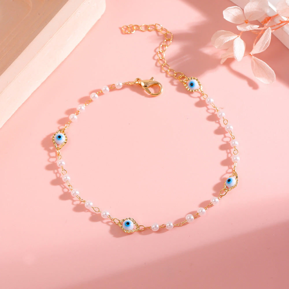 Elegant Pearl and Eye Charm Necklace Bowlift