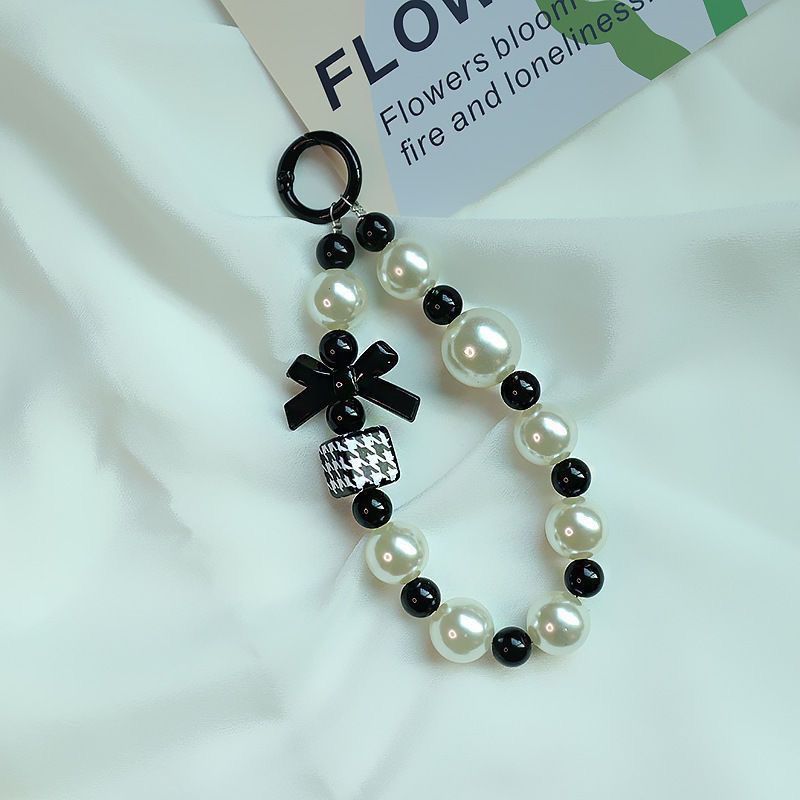 Elegant Pearl and Black Bead Charm Bracelet Bowlift