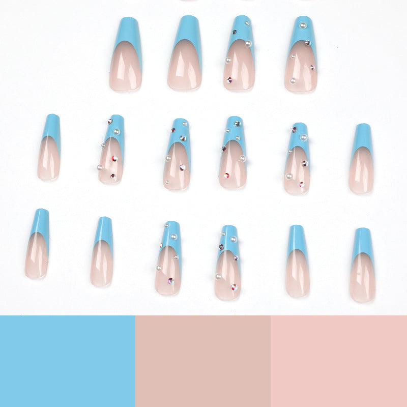 Artificial nail extensions with glitter and pearl accents Bowlift