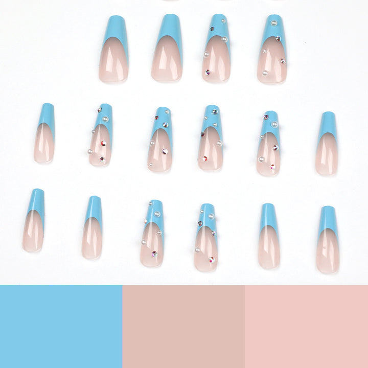 Artificial nail extensions with glitter and pearl accents Bowlift