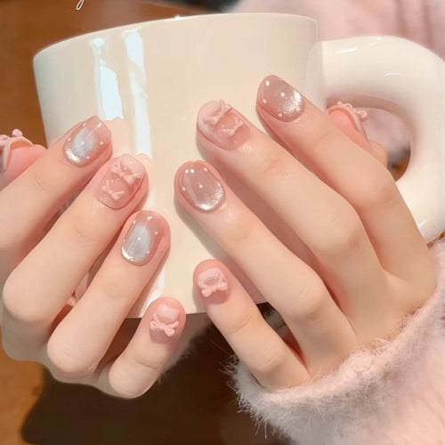 Artificial nails with delicate bow and glitter motifs Bowlift