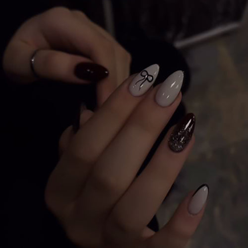 Artful nail art with elegant bow pattern and glitter accents Bowlift