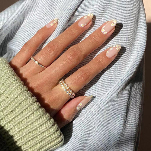 Artificial nail art with floral design and glitter accents Bowlift