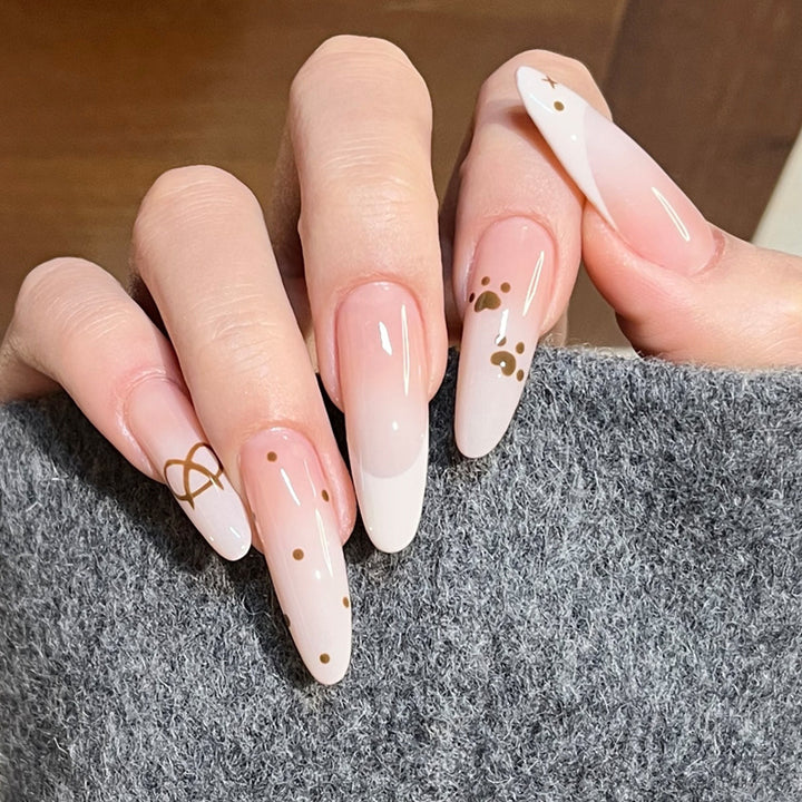 Glamorous Stiletto Press-On Nail Design with Elegant Gold Accents Bowlift