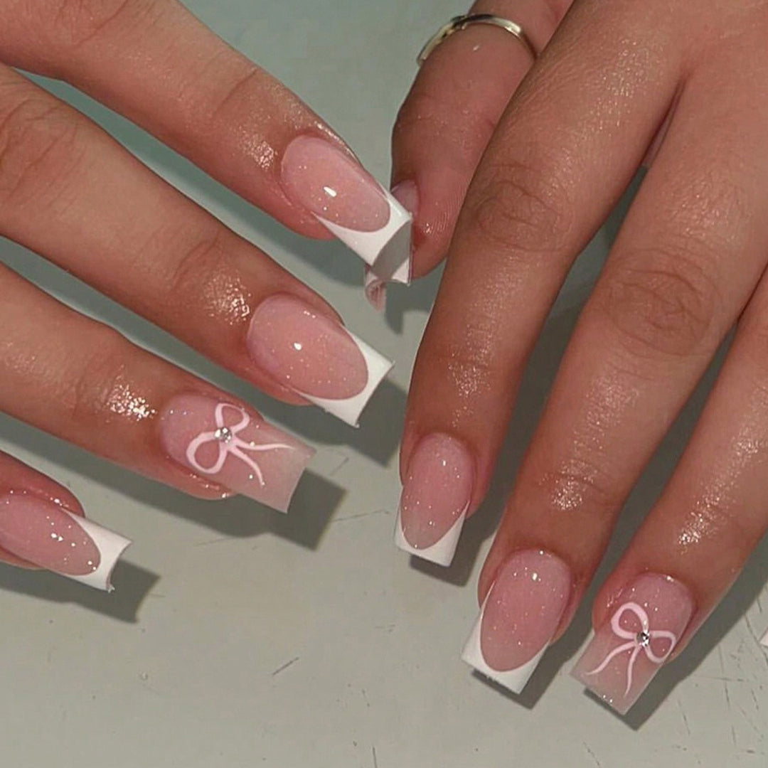 Nail art set with elegant bow and glitter accents Bowlift