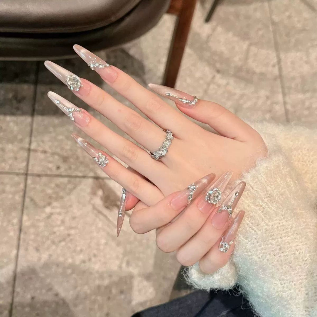 Acrylic nail set with elegant tips and glamorous rhinestone accents Bowlift