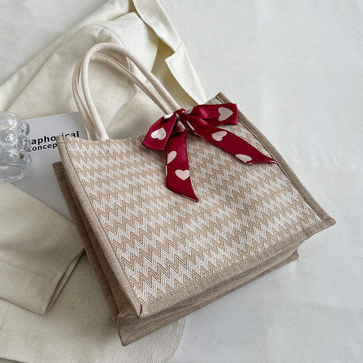 Textured Handbag with Decorative Bow