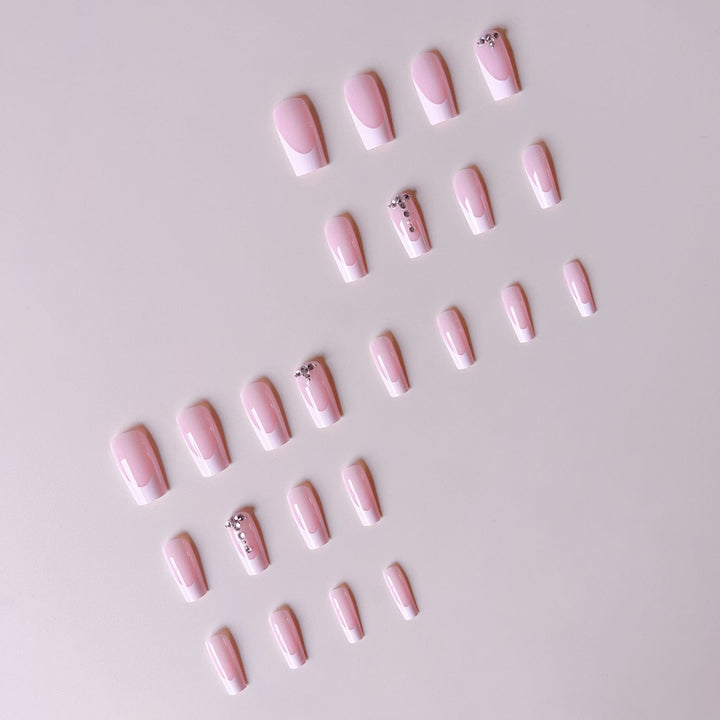 Acrylic nail set with elegant French tips and sparkling rhinestone accents Bowlift