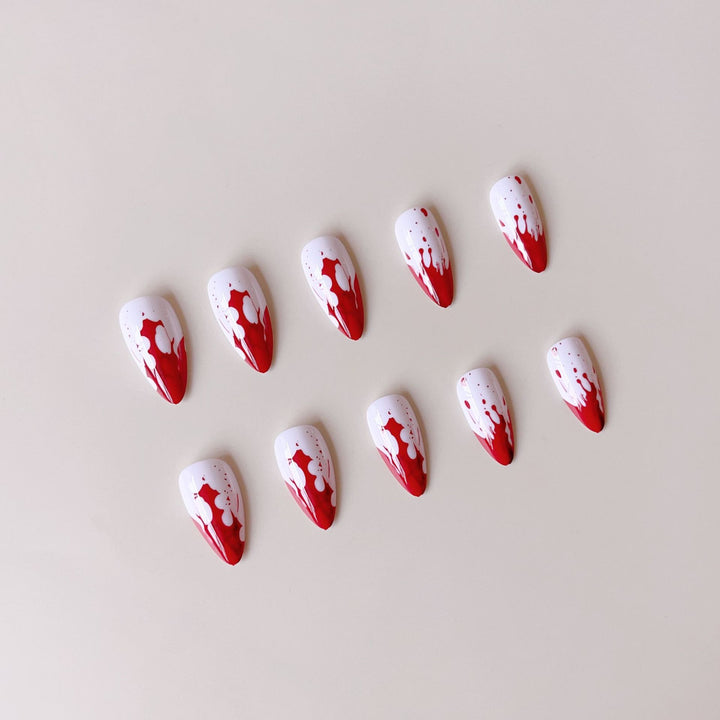 Artificial nail set with blood red inspired design and pointed accents Bowlift