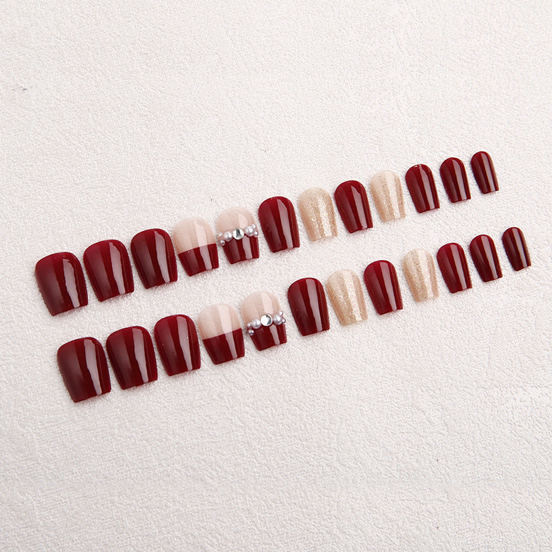 Glamorous artificial nails with glitter and pearl decorations Bowlift