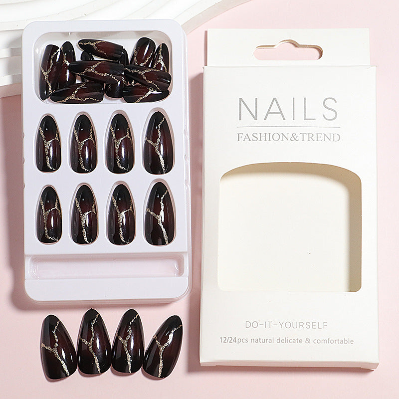 Artistic Press-On Nail Design with Gold Veining Accents Bowlift