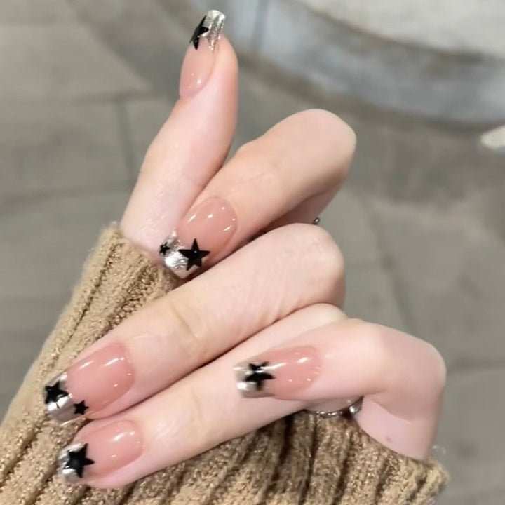 Sparkling nail art with stars and glitter accents Bowlift