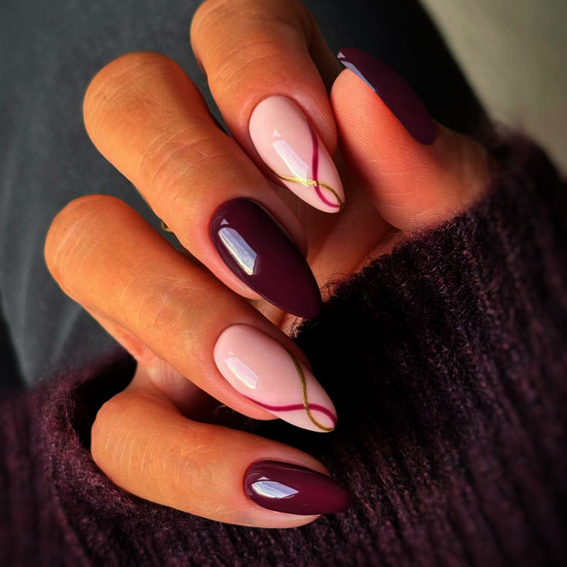 Artistic Almond-Shaped Press-On Nails with Elegant Gold Detailing Bowlift