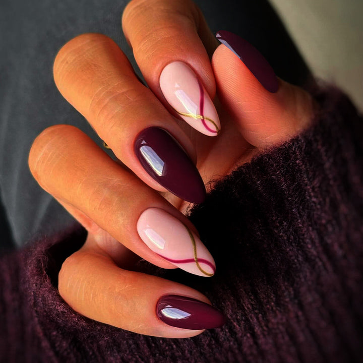 Artistic Almond-Shaped Press-On Nails with Elegant Gold Detailing Bowlift