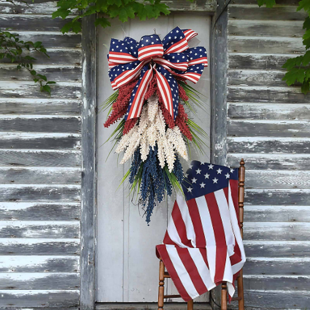 Independence Day tapering teardrop door swag with wired stars-and-stripes bow and textured faux floral sprays Bowlift