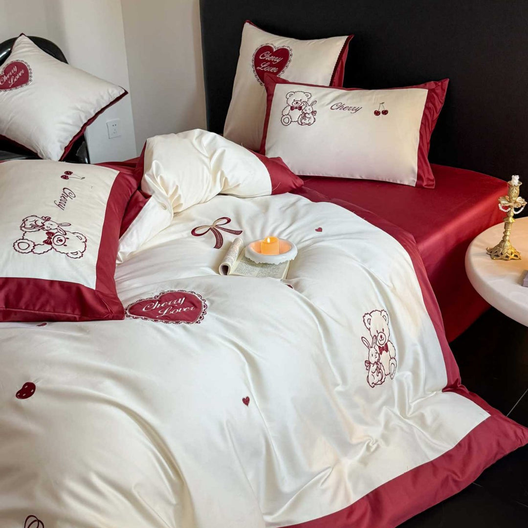 Cute cotton satin bedding set with embroidered teddy bear and cherry motifs, reversible function
